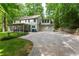 A two-car garage and screened porch enhance this home's exterior at 4219 Harrogate Nw Dr, Atlanta, GA 30327