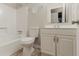 Standard bathroom with a toilet, shower and sink with cabinets at 4905 Sandberg Ct, Stone Mountain, GA 30088