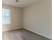A neutral bedroom is carpeted, and has a window allowing natural light to illuminate the room at 4905 Sandberg Ct, Stone Mountain, GA 30088