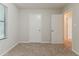 Neutral bedroom with an open closet, with carpet and a window allowing natural light to illuminate the room at 4905 Sandberg Ct, Stone Mountain, GA 30088