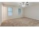 Large bedroom with carpet and two windows allowing natural light to illuminate the room, and ceiling fan at 4905 Sandberg Ct, Stone Mountain, GA 30088