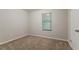 Neutral bedroom with a closet, carpet, and a window allowing natural light to illuminate the room at 4905 Sandberg Ct, Stone Mountain, GA 30088