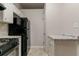 Functional kitchen boasts granite countertops, black appliances, and ample cabinet storage at 4905 Sandberg Ct, Stone Mountain, GA 30088