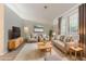Staged living room with neutral furniture, large windows, and modern decor at 4905 Sandberg Ct, Stone Mountain, GA 30088