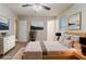 A spacious main bedroom has a neutral color palette with natural textures, plants, and large paintings at 4905 Sandberg Ct, Stone Mountain, GA 30088