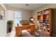 Cozy office space with hardwood desk, bookshelf, and natural light coming through the window at 4905 Sandberg Ct, Stone Mountain, GA 30088