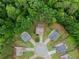 Aerial view of homes arranged in a circle, surrounded by lush, mature trees at 6160 Overleaf Ter, Cumming, GA 30040