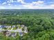 Picturesque neighborhood aerial view with homes nestled within mature, lush trees offering privacy and beauty at 6160 Overleaf Ter, Cumming, GA 30040