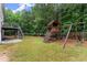 Spacious backyard with a wooden playset, and deck with stairs to the patio and yard at 6160 Overleaf Ter, Cumming, GA 30040