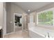 Bright, well-lit bathroom with soaking tub and glass enclosed shower at 6160 Overleaf Ter, Cumming, GA 30040