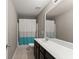 Bathroom featuring tile floors, a vanity with a white countertop, and a shower with a curtain at 6160 Overleaf Ter, Cumming, GA 30040