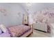 Floral-themed bedroom featuring custom wall art and a decorative chandelier at 6160 Overleaf Ter, Cumming, GA 30040