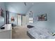 bedroom with blue walls, a vaulted ceiling, carpeted floor, and fun wall art at 6160 Overleaf Ter, Cumming, GA 30040