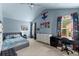 bedroom with blue walls, a vaulted ceiling, and superhero-themed decor, including a bed and desk at 6160 Overleaf Ter, Cumming, GA 30040
