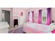 Bright bedroom featuring pink walls, purple curtains, and a cozy bed at 6160 Overleaf Ter, Cumming, GA 30040
