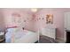 Pink-themed bedroom featuring a bed, dresser, and princess-themed decorations on the walls at 6160 Overleaf Ter, Cumming, GA 30040