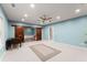 Large bonus room with ceiling fan, blue walls, carpet and sliding barn doors to another room at 6160 Overleaf Ter, Cumming, GA 30040