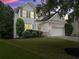 Two-story home boasts manicured lawn, complementing mature trees and well-kept landscaping at 6160 Overleaf Ter, Cumming, GA 30040