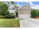 Charming two-story home with a well-manicured lawn and a two-car garage at 6160 Overleaf Ter, Cumming, GA 30040