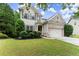 Charming two-story home boasts a well-manicured lawn and mature landscaping at 6160 Overleaf Ter, Cumming, GA 30040