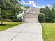 Inviting two-story home features a spacious driveway and a well-maintained lawn at 6160 Overleaf Ter, Cumming, GA 30040