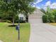 Well-maintained two-story home featuring an expansive driveway and lush front yard at 6160 Overleaf Ter, Cumming, GA 30040