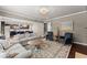 Open-concept living room with a fireplace and seamless flow to the kitchen at 6160 Overleaf Ter, Cumming, GA 30040