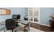 This home office features wood floors, gray craftsman desk, and natural light at 6160 Overleaf Ter, Cumming, GA 30040