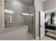 Stylish bathroom with a frameless glass shower, gray tile, and an open view to the bedroom at 148 Canton St, Alpharetta, GA 30009