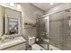 Bathroom featuring gray tile, glass shower door, granite countertops and modern fixtures at 148 Canton St, Alpharetta, GA 30009