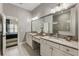 Well-lit bathroom with double sinks, granite countertops, a large mirror, and tile flooring at 148 Canton St, Alpharetta, GA 30009