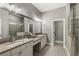 Luxurious bathroom boasting double vanity with stone countertop and frameless glass shower at 148 Canton St, Alpharetta, GA 30009
