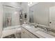 Bright bathroom with granite countertops, double sinks, and a shower with a glass sliding door at 148 Canton St, Alpharetta, GA 30009