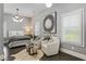 Charming bedroom with hardwood floors, a sitting area, and a decorative accent wall at 148 Canton St, Alpharetta, GA 30009