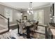 Elegant dining room with modern light fixture, stylish rug, and seating for six at 148 Canton St, Alpharetta, GA 30009