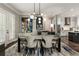 Elegant dining room with modern chandelier, stylish furniture, hardwood floors, and access to a gourmet kitchen at 148 Canton St, Alpharetta, GA 30009