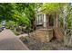 Beautiful home featuring a brick facade, landscaped front yard, and a cozy front porch with staircase and iron gate at 148 Canton St, Alpharetta, GA 30009