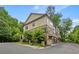 Exterior angle view of a multi-level brick and tan siding townhome at 148 Canton St, Alpharetta, GA 30009