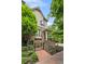 Beautiful home featuring a brick facade, landscaped front yard, and a cozy front porch with staircase and iron gate at 148 Canton St, Alpharetta, GA 30009