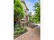 Beautiful home featuring a brick facade, landscaped front yard, and a cozy front porch with staircase and iron gate at 148 Canton St, Alpharetta, GA 30009