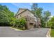 Exterior angle view of a multi-level brick and tan siding townhome at 148 Canton St, Alpharetta, GA 30009