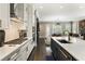 Modern kitchen with stainless appliances, stylish cabinets, and views into the living room at 148 Canton St, Alpharetta, GA 30009