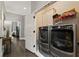 Convenient laundry room with stainless steel washer and dryer and overhead cabinets at 148 Canton St, Alpharetta, GA 30009