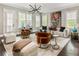 Bright living room featuring modern furnishings, large windows, and hardwood floors at 148 Canton St, Alpharetta, GA 30009