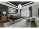 Elegantly designed main bedroom with a tray ceiling, designer chandelier, and neutral color scheme at 148 Canton St, Alpharetta, GA 30009