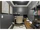 Home office with dark walls, gray carpet, desk, built-ins, and decor at 148 Canton St, Alpharetta, GA 30009