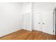 Bright bedroom with hardwood floors, closet, and two doors at 210 Walker Sw St # 3, Atlanta, GA 30313