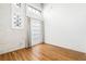 Bright bedroom with hardwood floors, white walls, and french door with outdoor access at 210 Walker Sw St # 3, Atlanta, GA 30313