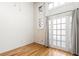 Bright bedroom with hardwood floors, white walls, and french door with outdoor access at 210 Walker Sw St # 3, Atlanta, GA 30313