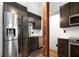 Modern kitchen with stainless steel appliances, wooden floors, and dark cabinetry at 210 Walker Sw St # 3, Atlanta, GA 30313
